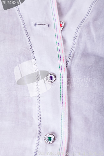 Image of Closeup Small Buttons on White Cloth