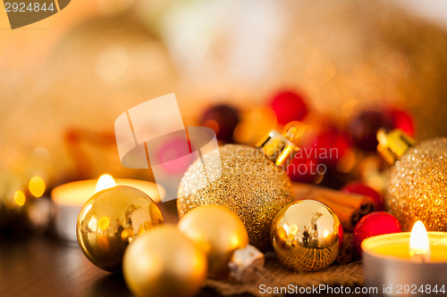 Image of Warm gold and red Christmas candlelight background