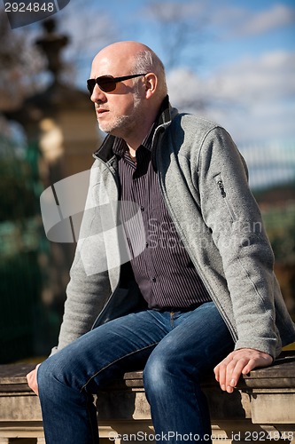 Image of Stylish man in sunglasses enjoying the sun