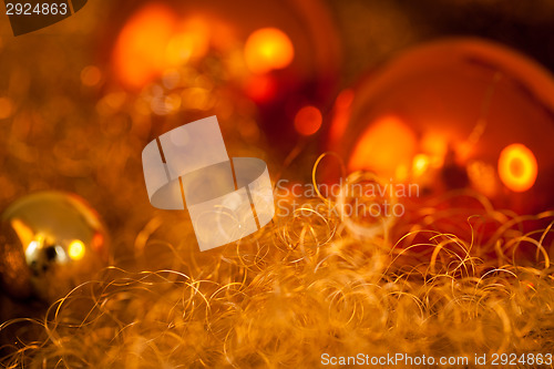 Image of Warm gold and red Christmas candlelight background