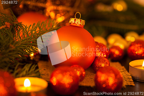 Image of Warm gold and red Christmas candlelight background