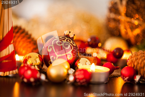 Image of Warm gold and red Christmas candlelight background