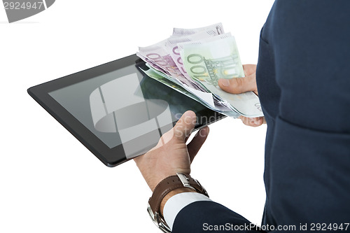 Image of Businessman using a tablet computer