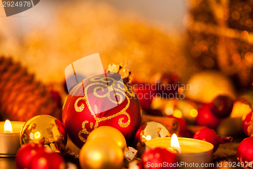 Image of Warm gold and red Christmas candlelight background