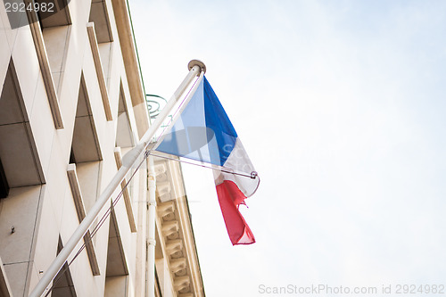 Image of Flag of France fluttering under a serene blue sky