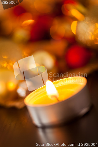 Image of Warm gold and red Christmas candlelight background