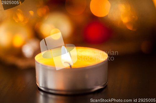 Image of Warm gold and red Christmas candlelight background