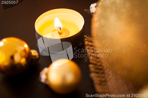 Image of Warm gold and red Christmas candlelight background