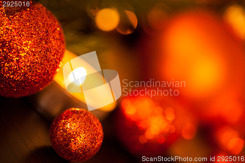 Image of Warm gold and red Christmas candlelight background