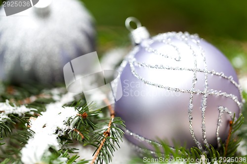 Image of Silver Christmas ornaments in leaves