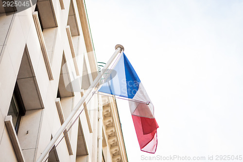 Image of Flag of France fluttering under a serene blue sky