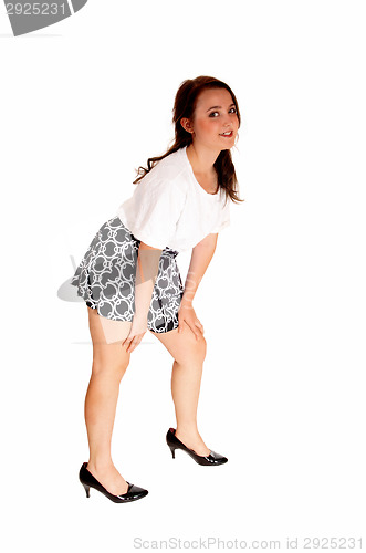Image of Teen girl bending down.