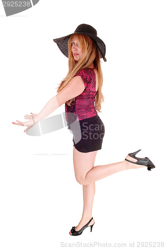 Image of Woman in shorts and hat.