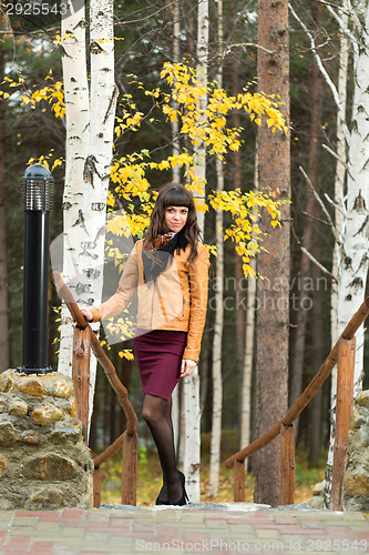 Image of Charming girl in the autumn forest