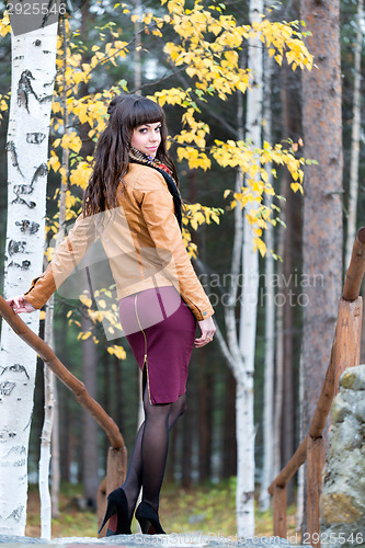 Image of Charming girl in the autumn forest.