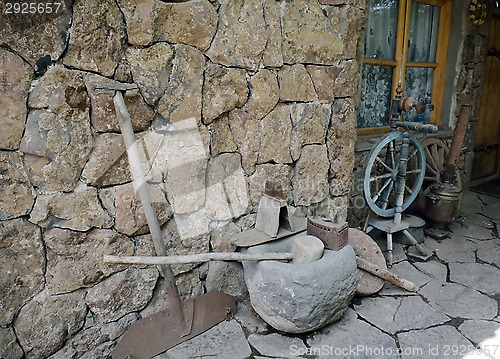 Image of ancient tools and everyday objects next to the wall 