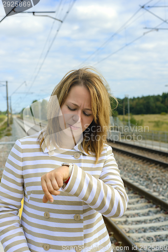 Image of Portrait of a beautiful woman watching her watch