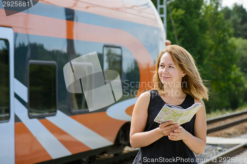 Image of Girl holding map and watching on a train