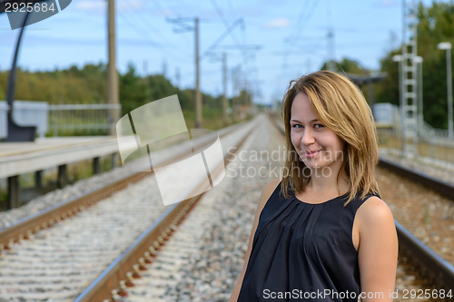 Image of Portrait of girl between two railway path