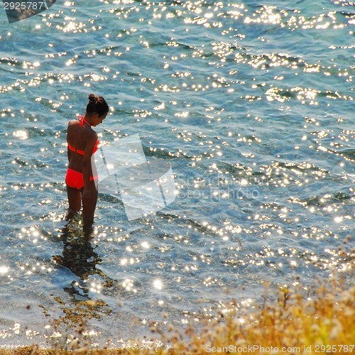 Image of Girl in sunny sea water