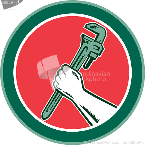 Image of Hand Holding Adjustable Wrench Circle Woodcut