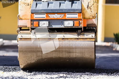 Image of Asphalt surfacing manual labor.