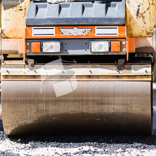 Image of Asphalt surfacing manual labor.