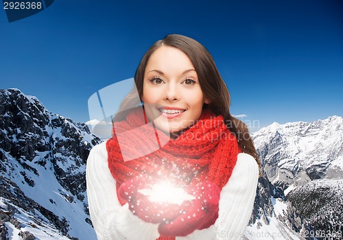 Image of smiling woman in winter clothes with snowflake