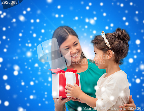 Image of happy mother and child girl with gift box