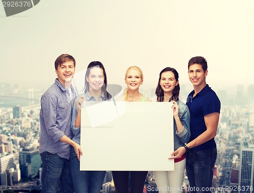 Image of group of standing students with blank white board