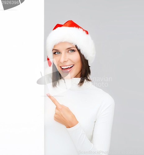 Image of woman in santa helper hat with blank white board