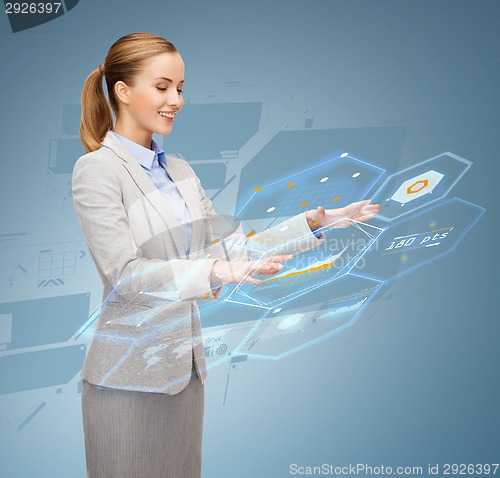 Image of smiling businesswoman working with virtual screen