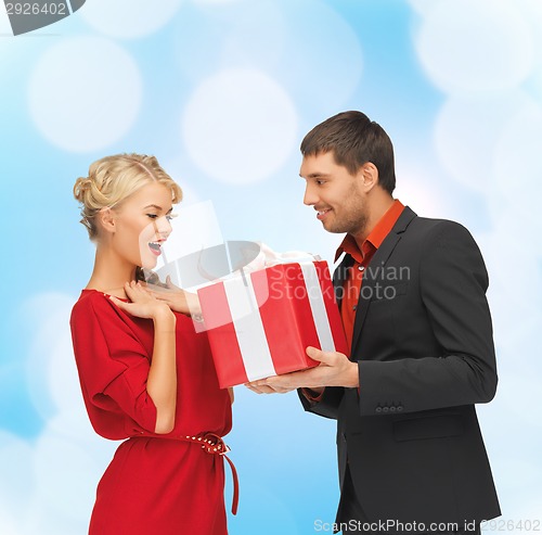 Image of smiling man and woman with present