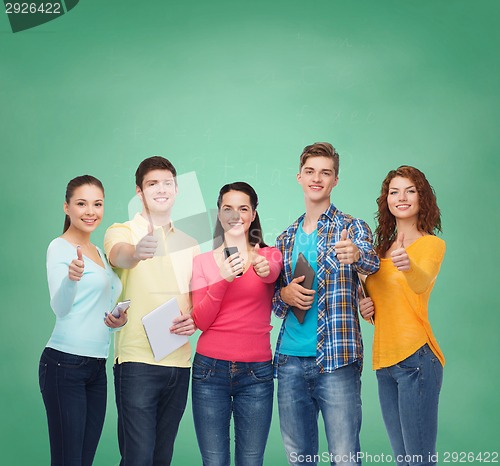 Image of group of teenagers with smartphones and tablet pc