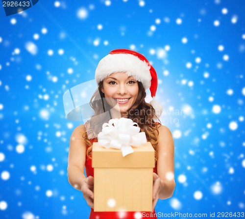 Image of smiling woman in red dress with gift box