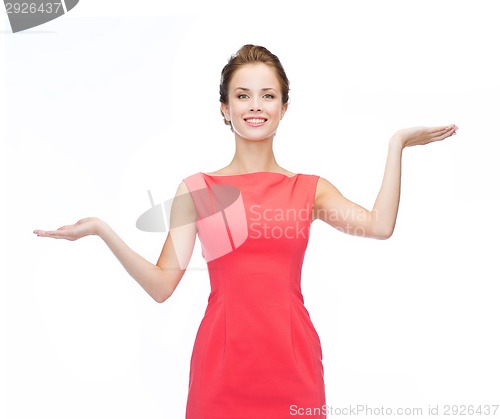 Image of smiling woman holding something imaginary on palms