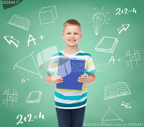 Image of smiling little student boy with blue book