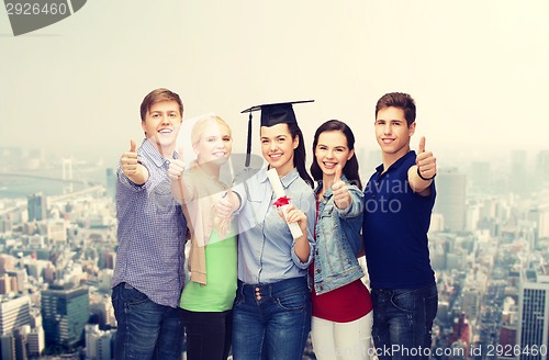 Image of group of students with diploma showing thumbs up