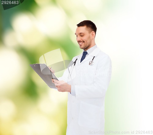 Image of smiling male doctor with clipboard and stethoscope