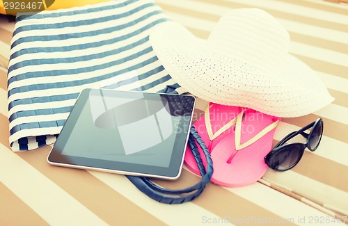 Image of close up of tablet pc on beach