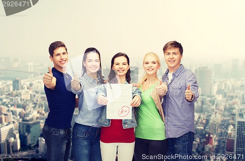 Image of group of students showing test and thumbs up