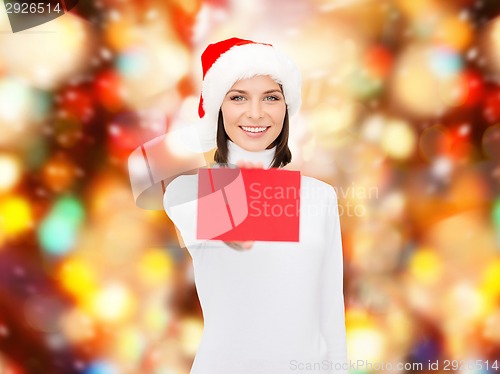 Image of woman in santa helper hat with blank red card
