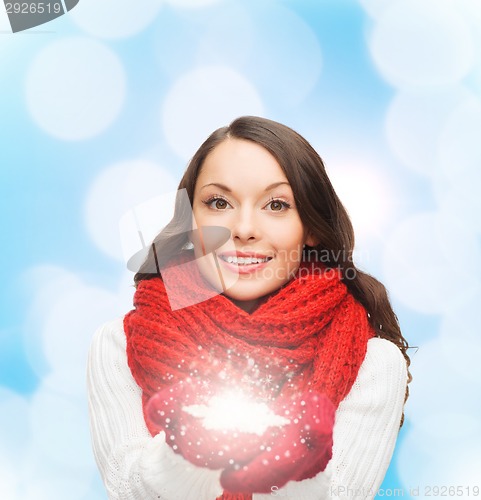 Image of smiling woman in winter clothes with snowflake