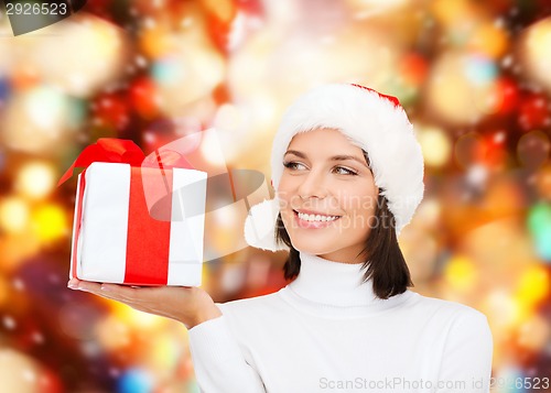 Image of smiling woman in santa helper hat with gift box