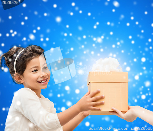 Image of smiling little girl with gift box