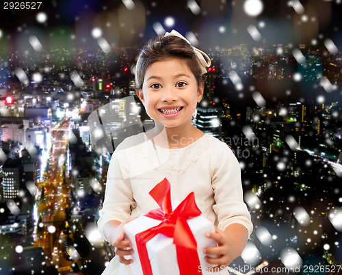 Image of smiling little girl with gift box