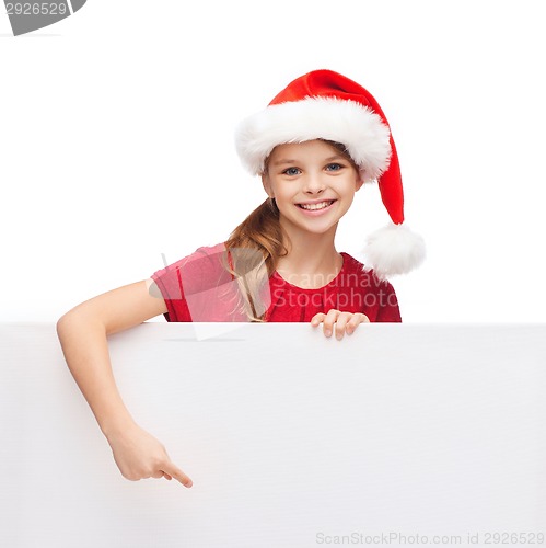 Image of child in santa helper hat with blank white board