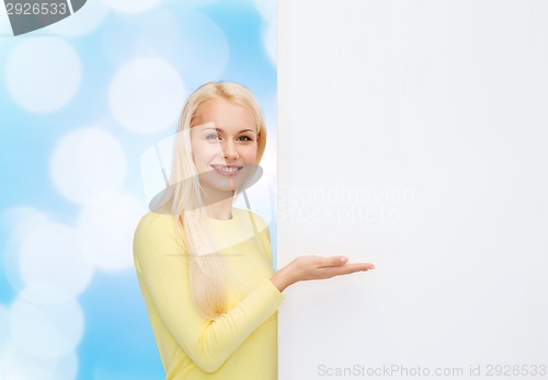 Image of smiling woman in sweater with blank white board