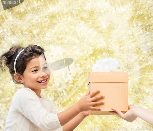 Image of smiling little girl with gift box