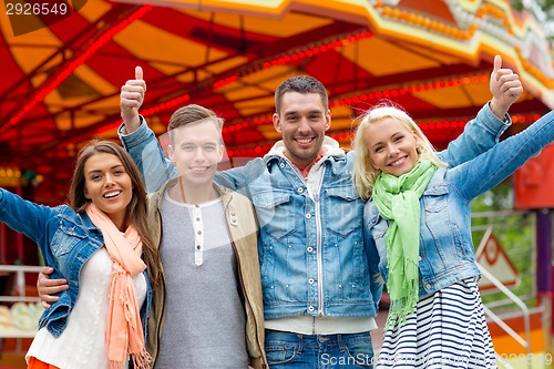 Image of group of smiling friends showing thumbs up